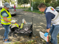 Menschen mit Warnwesten und Müllsäcken